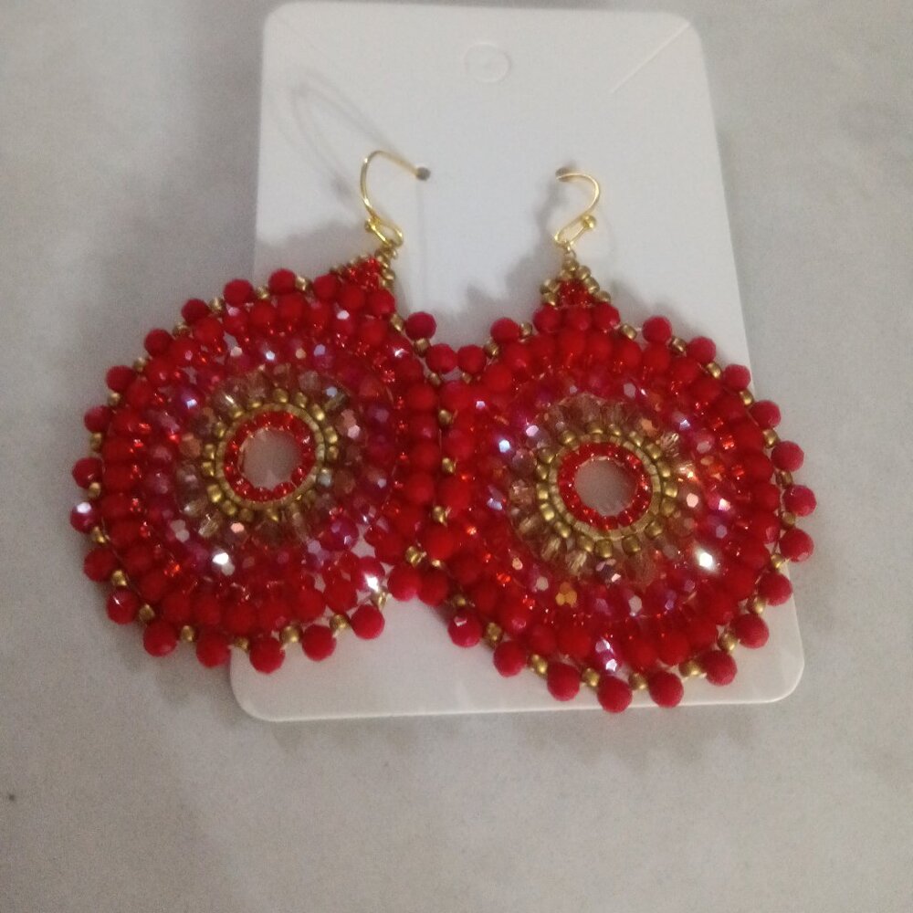 A pair of beaded circle earrings in rich warm shades of brown.